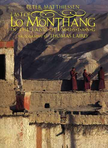 
Monks on the walls of Lo Manthang blow horns to announce the end of the Tiji Festival - East of Lo Monthang book cover
